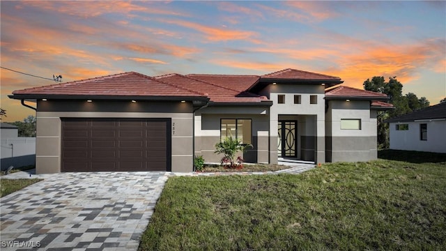 view of front of house with a yard and a garage