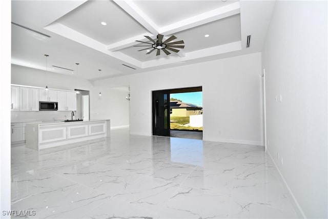 unfurnished living room with ceiling fan, sink, beam ceiling, and coffered ceiling