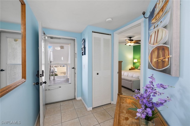 doorway with light tile patterned floors