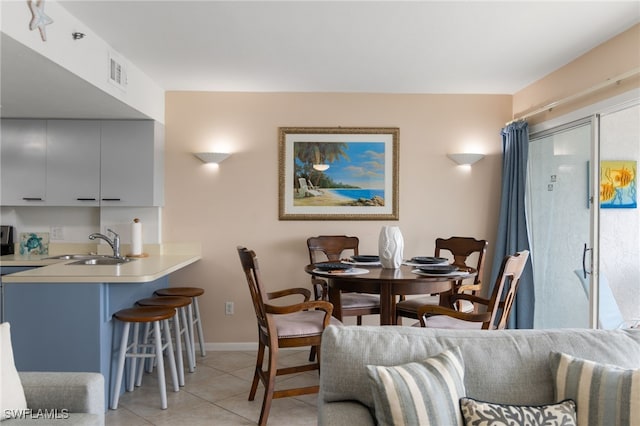 dining area with sink and light tile patterned floors