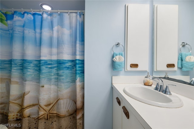 bathroom with walk in shower and vanity