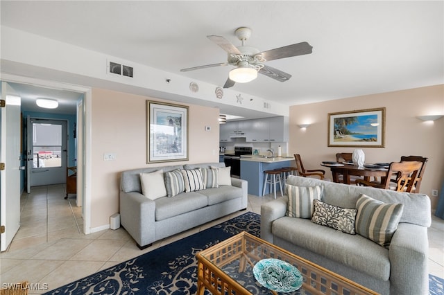 tiled living room with ceiling fan