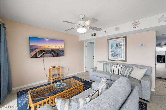 tiled living room featuring ceiling fan