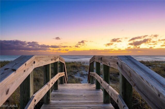 view of home's community featuring a water view and a view of the beach