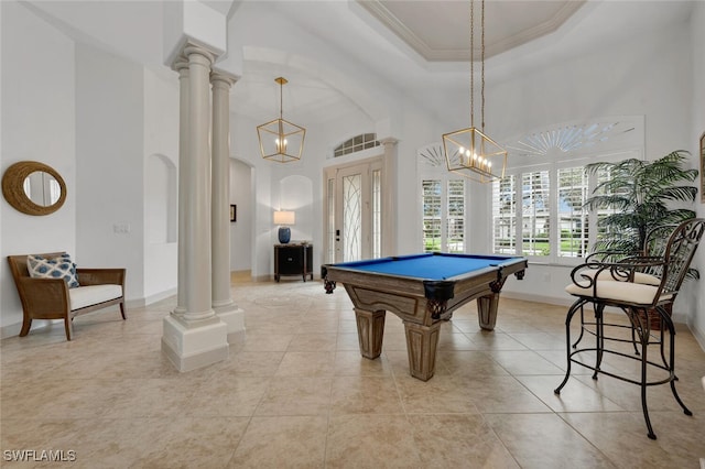 game room featuring ornate columns, light tile patterned flooring, crown molding, and a raised ceiling