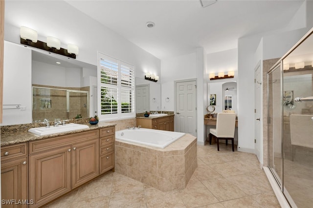 bathroom with tile patterned flooring, vanity, and shower with separate bathtub