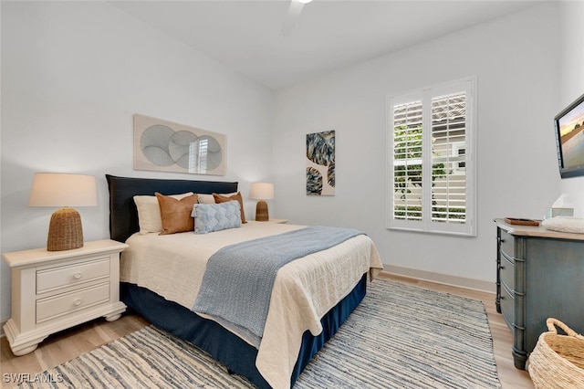 bedroom with ceiling fan and light hardwood / wood-style flooring