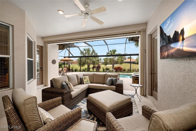 sunroom featuring ceiling fan