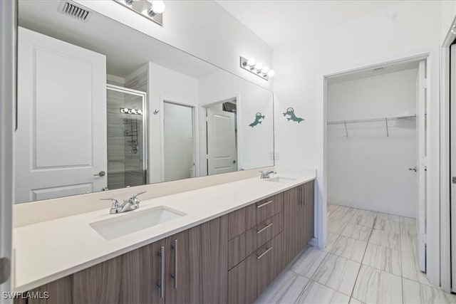 bathroom featuring walk in shower and vanity