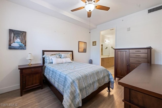 bedroom with ceiling fan, connected bathroom, and wood-type flooring