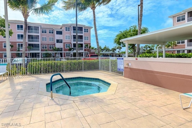 view of pool with a patio area and a community hot tub