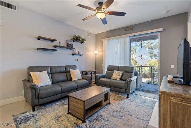 living room featuring ceiling fan and light tile patterned floors