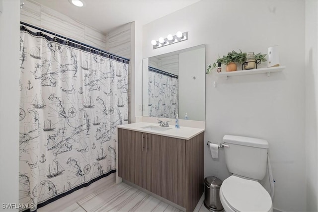 bathroom with toilet, a shower with shower curtain, and vanity