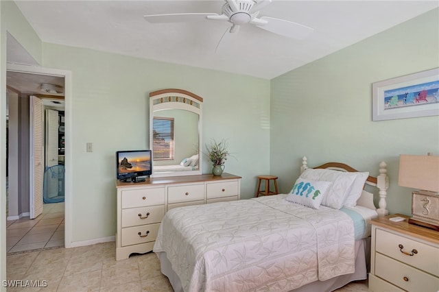 bedroom featuring light tile patterned flooring and ceiling fan