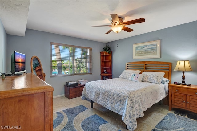 bedroom featuring light tile patterned floors and ceiling fan