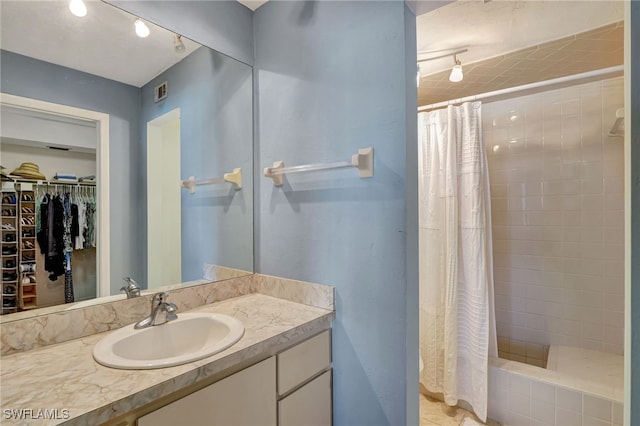 bathroom with vanity and curtained shower