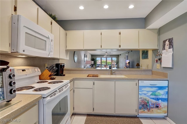 kitchen with white cabinetry, white appliances, sink, and light tile patterned floors