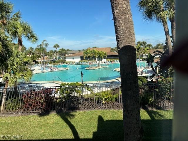 view of pool featuring a yard