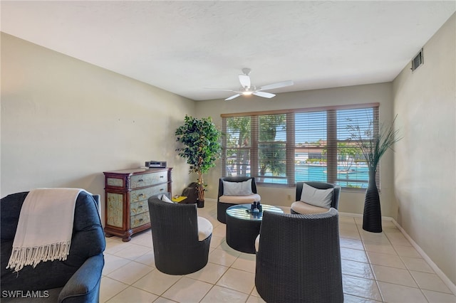 living room featuring light tile patterned floors, a wealth of natural light, and ceiling fan