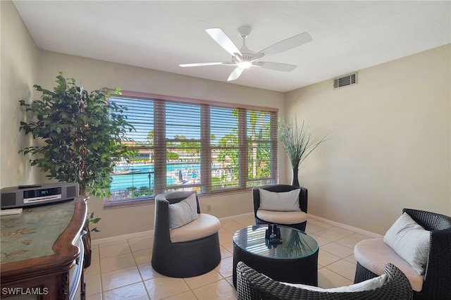 sitting room featuring light tile patterned floors and ceiling fan