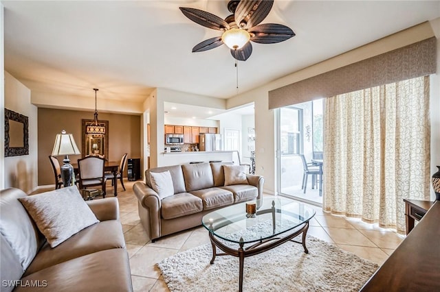 living room with ceiling fan and light tile patterned flooring