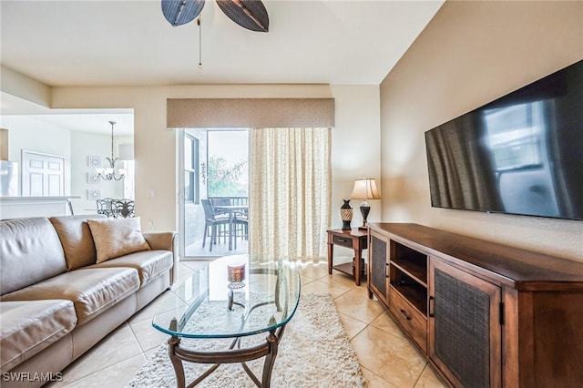 living room featuring ceiling fan with notable chandelier and light tile patterned floors