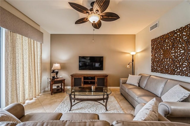 tiled living room featuring ceiling fan