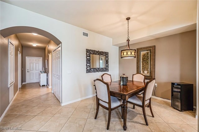 dining space featuring light tile patterned floors and wine cooler