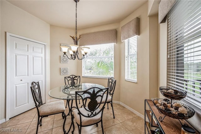 tiled dining space with an inviting chandelier