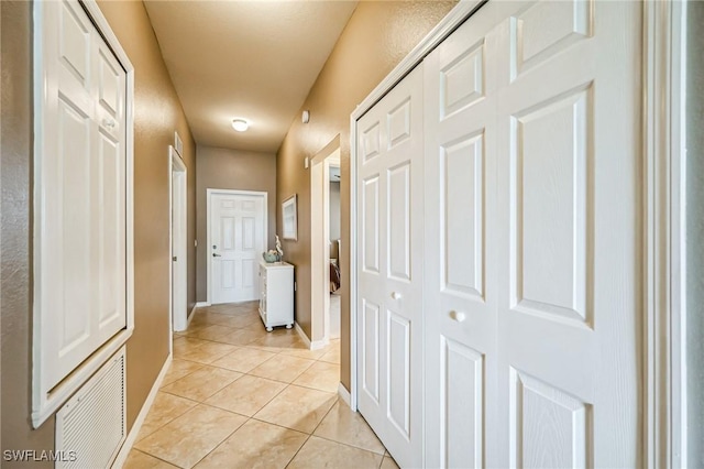 corridor featuring light tile patterned flooring