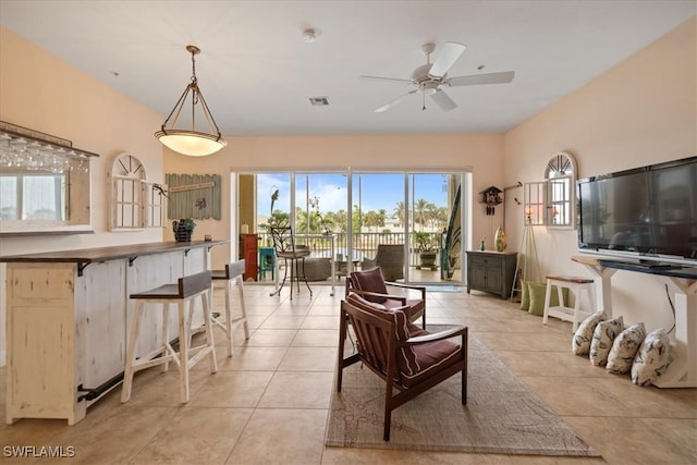 tiled living room with ceiling fan