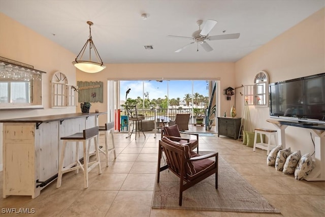 living room featuring ceiling fan and light tile patterned floors