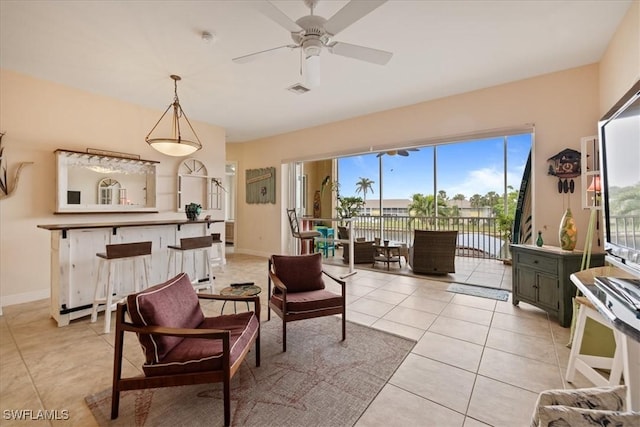 sitting room with ceiling fan and light tile patterned flooring