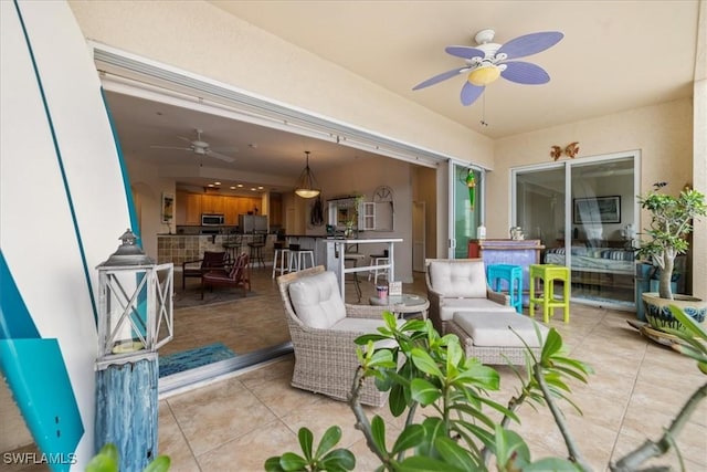 view of patio with ceiling fan, an outdoor hangout area, and exterior bar