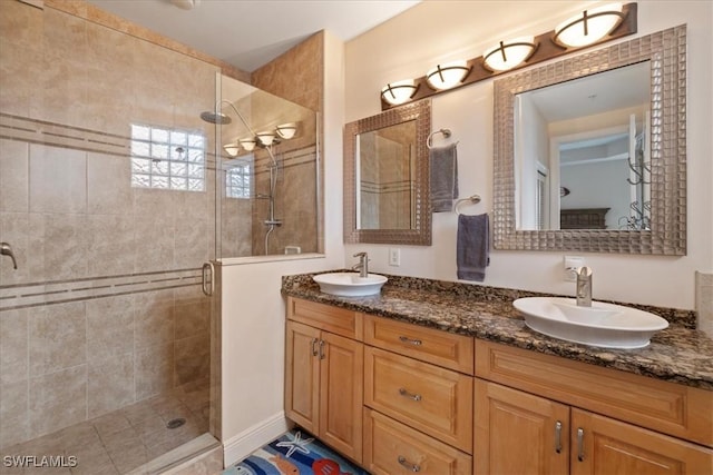 bathroom featuring walk in shower and vanity