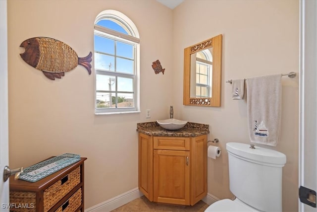 bathroom featuring toilet and vanity