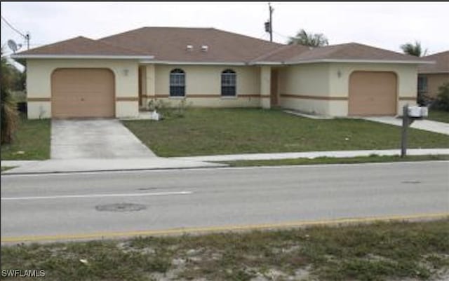 single story home with a front yard and a garage