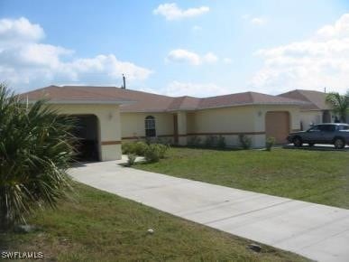 ranch-style house with a front yard and a garage