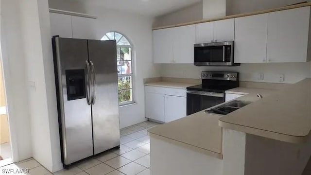 kitchen featuring a wealth of natural light, stainless steel appliances, white cabinetry, and sink