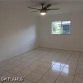 spare room featuring ceiling fan and tile patterned flooring