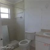 bathroom with toilet and vanity