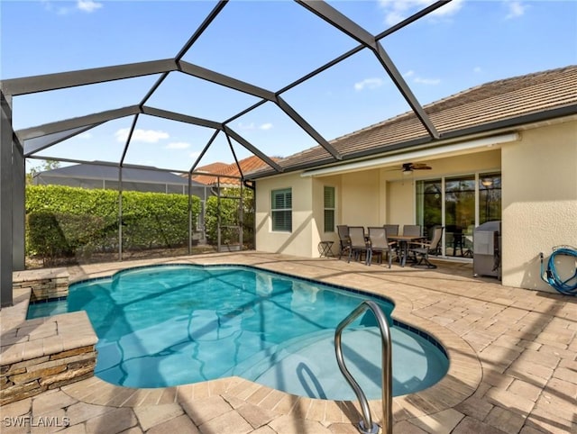 view of swimming pool featuring a lanai, a patio area, and ceiling fan