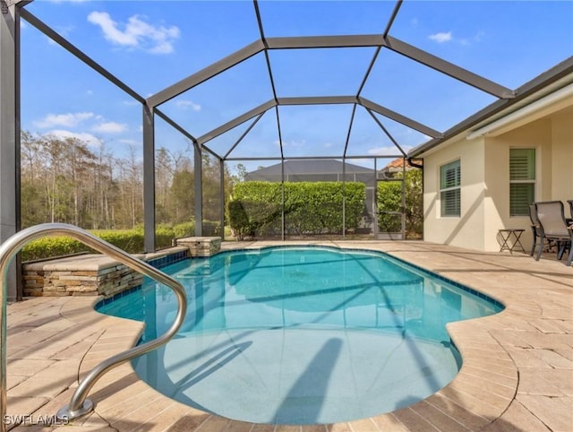 view of pool featuring a patio and glass enclosure