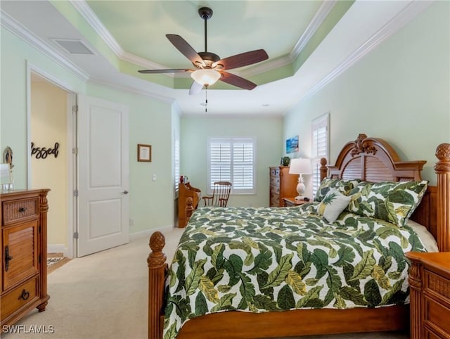 bedroom featuring ceiling fan, a raised ceiling, ornamental molding, and light carpet