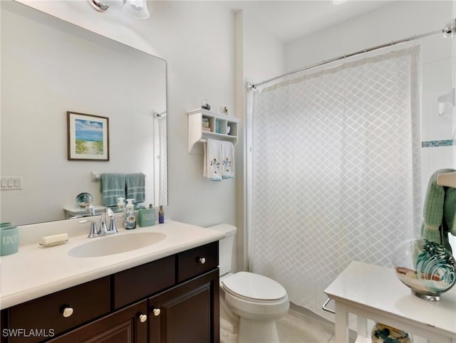 bathroom featuring curtained shower, toilet, and vanity