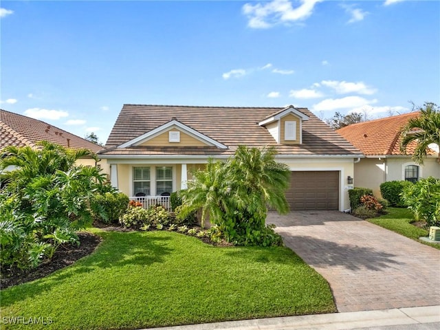 view of front of house featuring a garage, a front lawn, and a porch