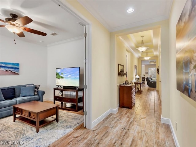 corridor featuring light hardwood / wood-style floors and crown molding