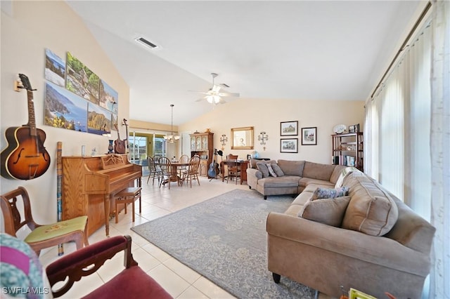 living room featuring ceiling fan with notable chandelier, vaulted ceiling, and light tile patterned floors