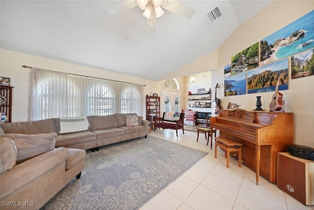 living room with lofted ceiling, light tile patterned floors, and ceiling fan