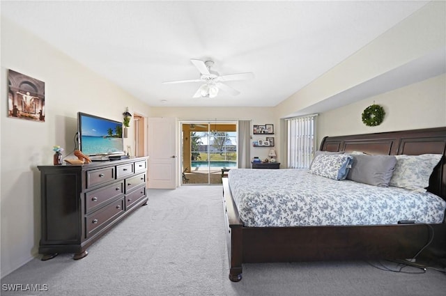 bedroom with ceiling fan, access to exterior, and light carpet